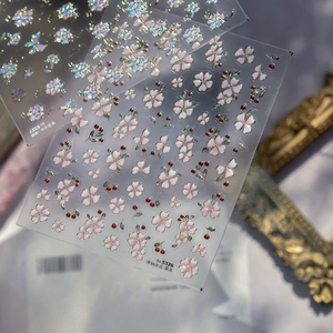 Detail of 3D jelly nail art stickers featuring pink peach blossoms and pearly butterflies