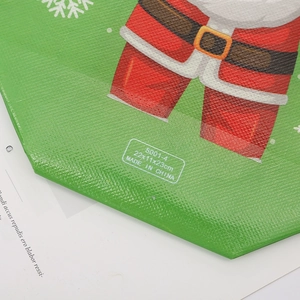 Foldable green Christmas non-woven gift bag with size 22x11x23cm and festive pattern