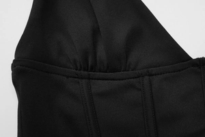 Detail of black camisole showing pleated fabric texture and professional stitching work