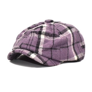 Detail of purple plaid wool newsboy cap with classic top button and structured brim