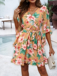 Detail of floral print chiffon dress with V-neck wrap design and ruffled short sleeves