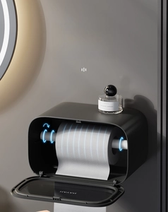 Macro detail of wall-mounted black matte paper holder with open front cover and white roller