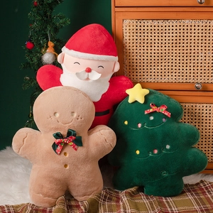 Close-up of Santa Claus, Gingerbread Man, and Christmas Tree plush decor in a festive room