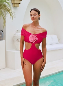 Detail of rose pink one-piece swimsuit featuring a 3D floral accent and waist cutouts