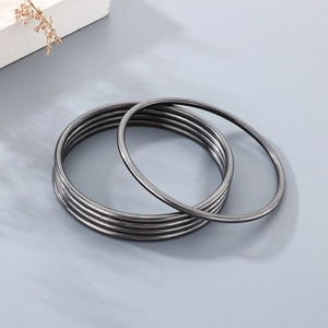 Detail view of 3mm black titanium steel round bangles with a vintage matte finish
