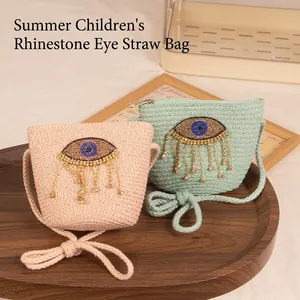 Kids woven straw crossbody bag with evil eye rhinestone and tassel fringe detail