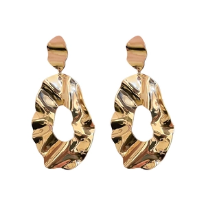 Elegant gold irregular wavy tassel earrings with flower stud detail in a minimalist style