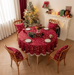 Close-up of red Christmas reindeer tablecloth featuring elegant white tassel lace edges