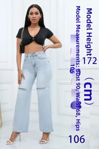 Light blue high waist flared jeans with knee distress and chic ripped hole detailing
