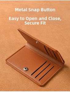 Detail of brown lychee grain leather card wallet with six card slots and silver snap button