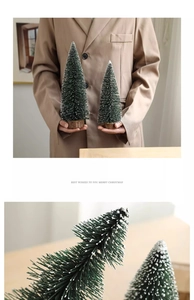 Macro detail of artificial mini Christmas trees with white flocking and round wood bases