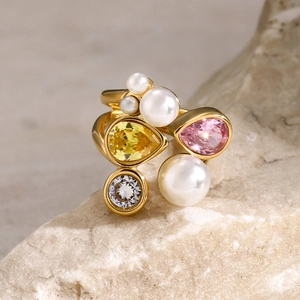 Macro detail of 18k gold plated ring with pearls, teardrop gems and white zircon