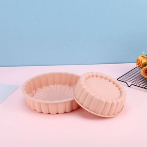 Pink sunflower silicone cake mold set with pleated texture on blue and pink background