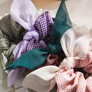 Close-up of sweet plaid and solid chiffon scrunchies with elegant handmade bow detail