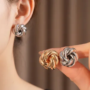 Minimalist polished metal swirl flower stud earrings in gold and silver finishes