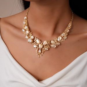 Close-up of vintage gold teardrop crystal necklace set with elegant layered diamond flowers