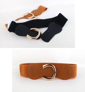 Detail view of elastic waist belts in various colors featuring golden C-shape metal buckles