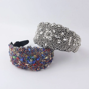 Detailed macro view of baroque geometric wide headbands with shiny silver and colorful crystals