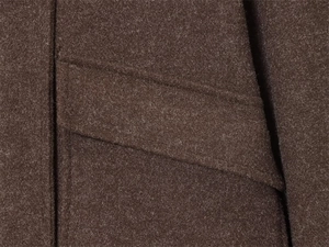 Macro shot of dark brown wool coat pocket flap showing fine stitching and fabric texture