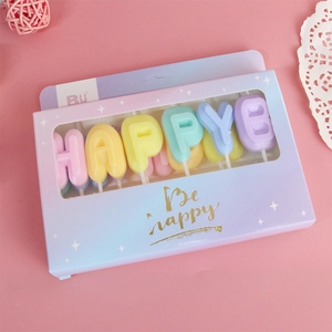 Colorful macaron letter candles spelling HAPPY BIRTHDAY in a premium gift box