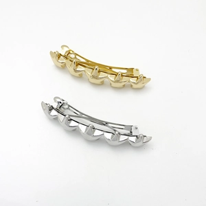 Detailed view of eco-friendly alloy star hair clips in polished gold and silver finishes
