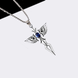Macro shot of silver cross pendant with blue gemstone and wings on a box chain