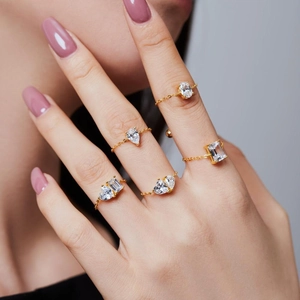 Adjustable gold chain rings with oval and pear shaped clear cubic zirconia stones