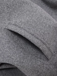 Close-up of the pocket detail showing stitching on the gray soft fleece bomber jacket