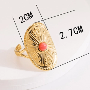 Detailed view of bohemian gold shield ring with sunburst pattern and orange natural stone