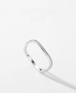 Close-up of geometric S925 silver wavy ring with micro-pave crystals on a clean background