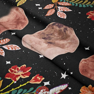 Close-up of bohemian floral tapestry fabric with soft velvet texture and celestial stars