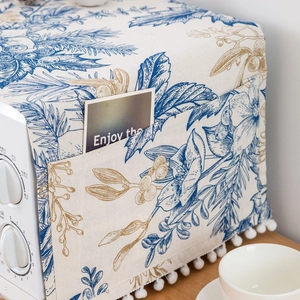 Linen microwave dust cover with floral patterns, side storage pockets and pompom trim