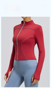 Detail of dark red reflective sports jacket with gray piping and thumbhole cuffs