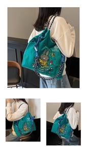 Detail of green canvas tote with cute rabbit embroidery and thick woven rope straps