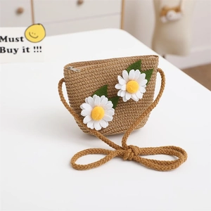 Detailed view of child handmade straw crossbody bag with white daisy flower accents