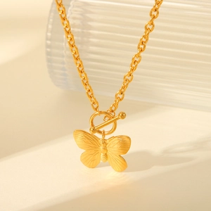 Macro shot of gold stainless steel butterfly pendant with OT toggle clasp and bead chain