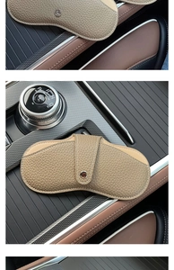 Car dashboard detail of lychee grain leather glasses pouch in khaki with snap button