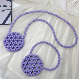 Handmade purple beaded crossbody bag with acrylic pearls and woven round design