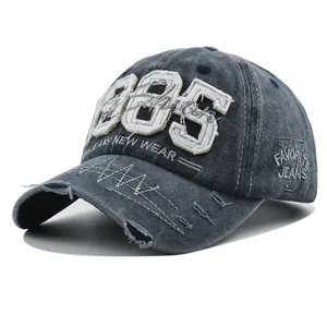 Detailed close-up of 1985 embroidery and distressed denim texture on baseball cap