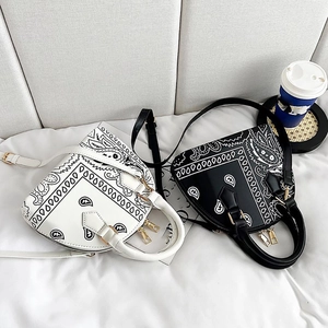 Detail of vintage bandana pattern handbags in black and white with gold zippers