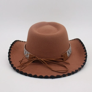 Detail of brown wool fedora with black contrast stitching and geometric woven band