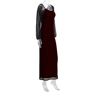Detailed view of burgundy maxi dress featuring sheer black mesh sleeves and hemline trim