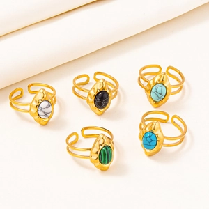 Set of 5 bohemian gold hammered rings with colorful marble stones on neutral fabric