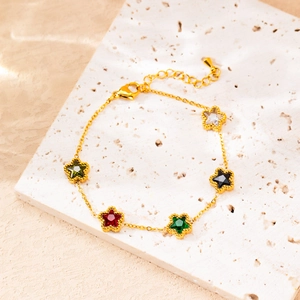 Gold plated stainless steel bracelet featuring five colorful star-shaped gemstone charms