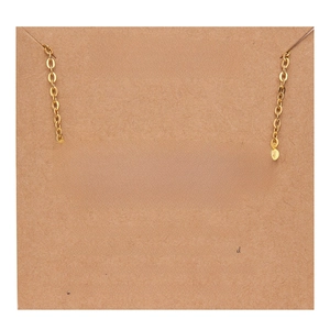Macro view of gold Sagittarius necklace on vintage kraft paper card with character description