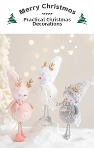 Close-up of plush snowman and reindeer figurines with soft scarves in a snowy Christmas scene