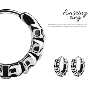 Detailed macro view of retro silver skull relief patterns on punk stainless steel earrings