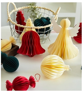 Detail view of honeycomb paper Christmas ornaments in angel, bell and sphere shapes