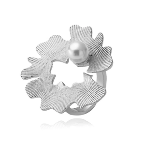Macro shot of silver jasmine flower ring featuring a white pearl and textured metal petals