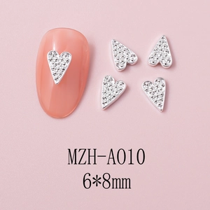 Macro view of heart-shaped rhinestones for nail art showing 6x8mm size details
